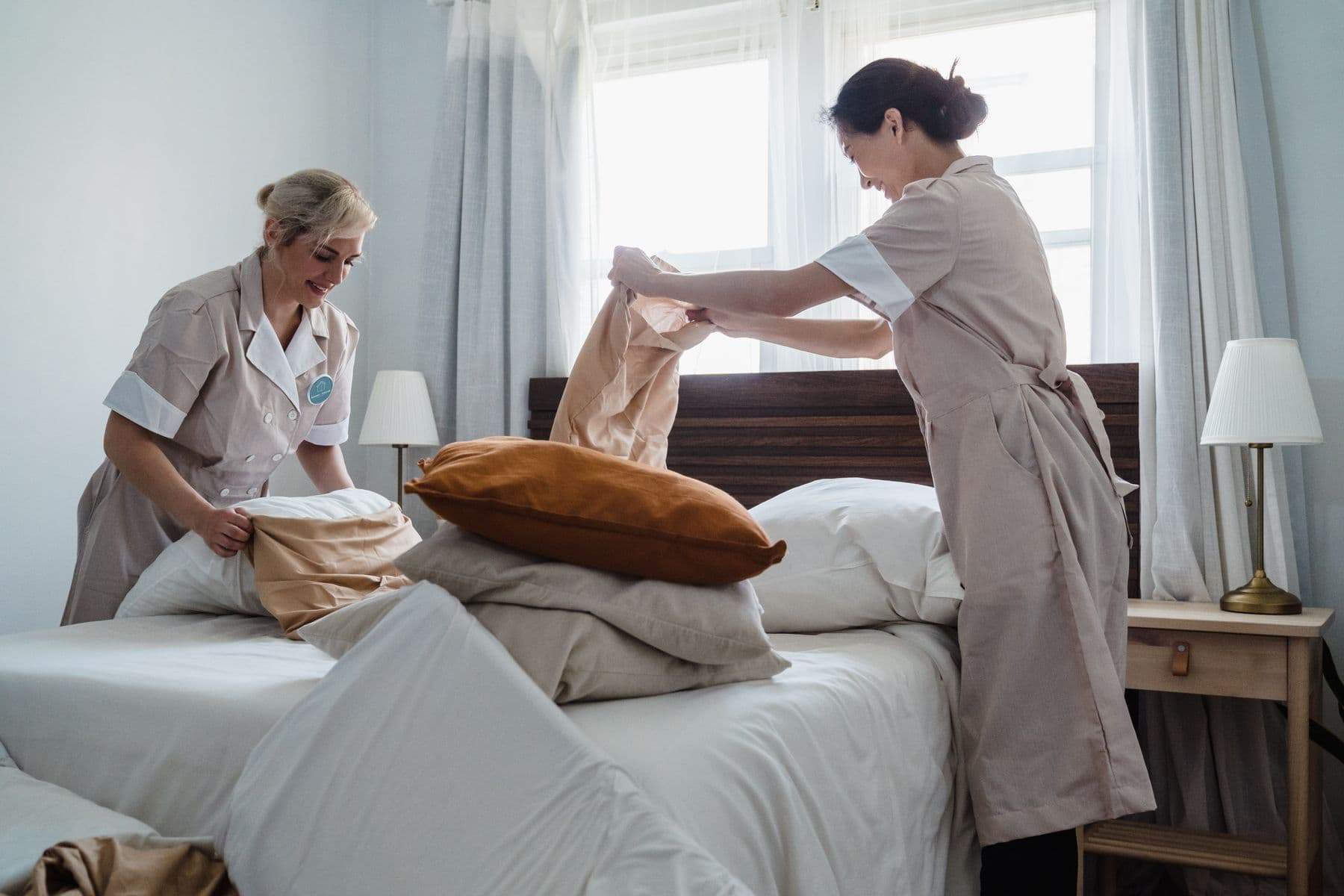 Housekeepers making a hotel bed